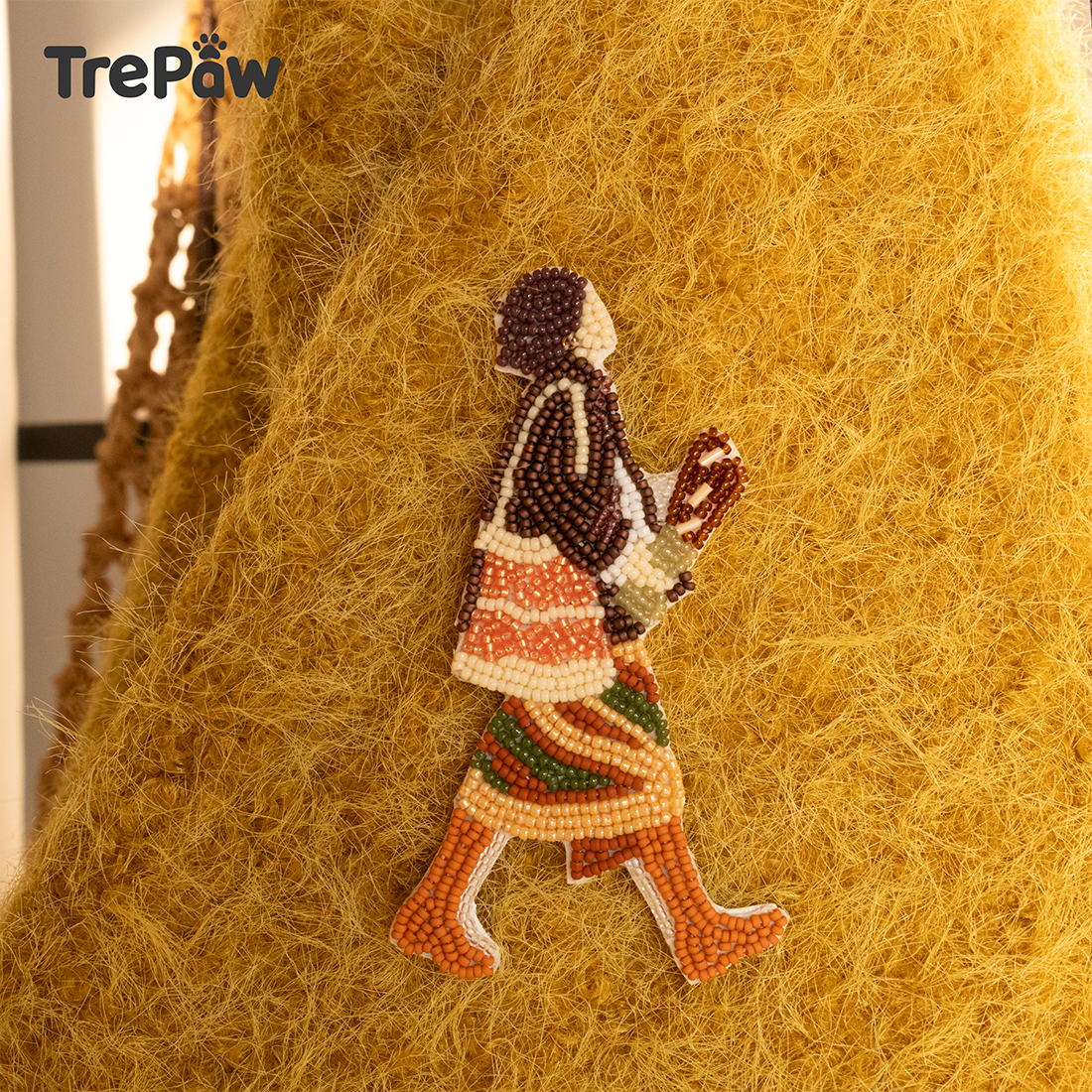 Leopard Lady bead embroidery hanging charm styled on a handbag as a fashion-inspired handmade accessory.