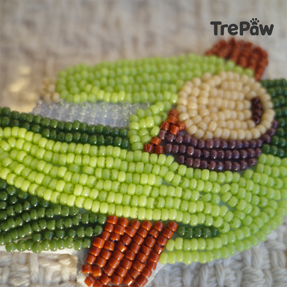 Close-up of 6PM bead embroidery showing a tired girl in an oversized green outfit