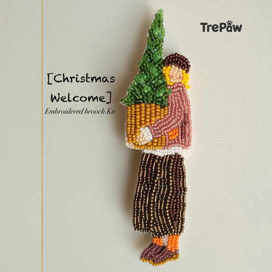 Christmas Welcome handmade bead embroidery brooch featuring a happy girl hugging a small potted Christmas tree.