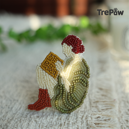 Close-up of Jane bead embroidery showing the girl reading a book and vintage-inspired outfit