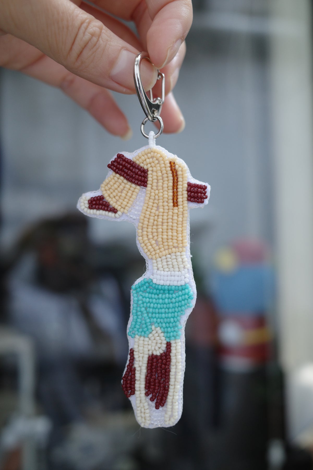 Close-up of Lazy Sunday bead embroidery showing the upside down girl and blue outfit