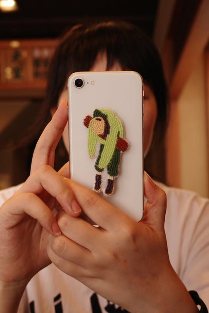 6PM handmade bead embroidery charm attached to a phone case