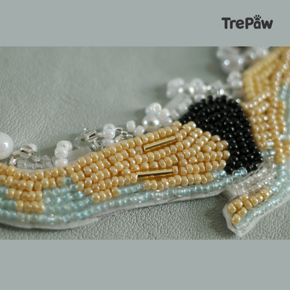 Close-up of Emerge bead embroidery showing the figure and pearl-like decorative details