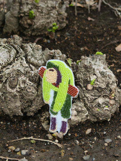 6PM beaded character charm hanging from a bag