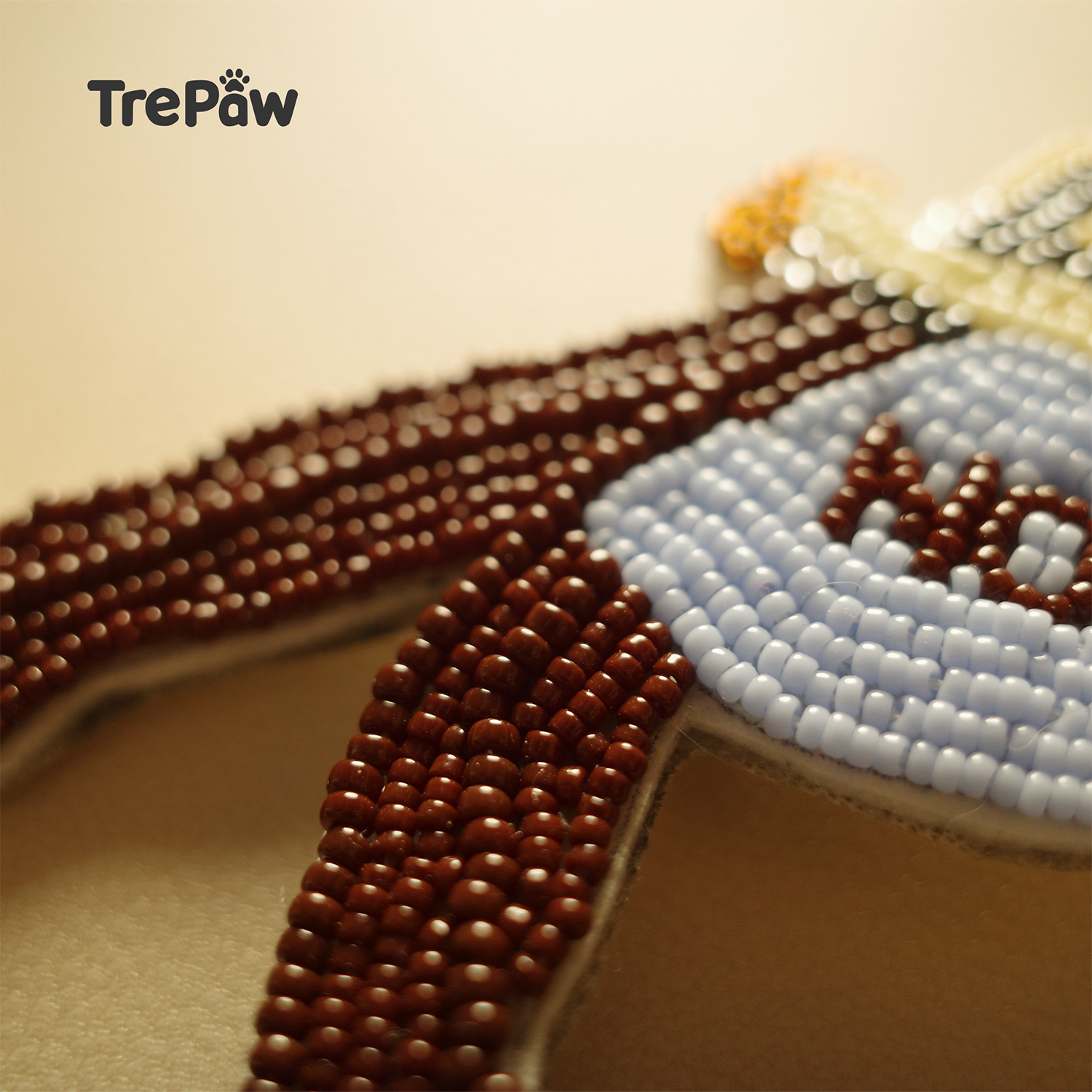 Close-up of I Said No bead embroidery showing the girl's metallic top, wine-red trousers and blue bag