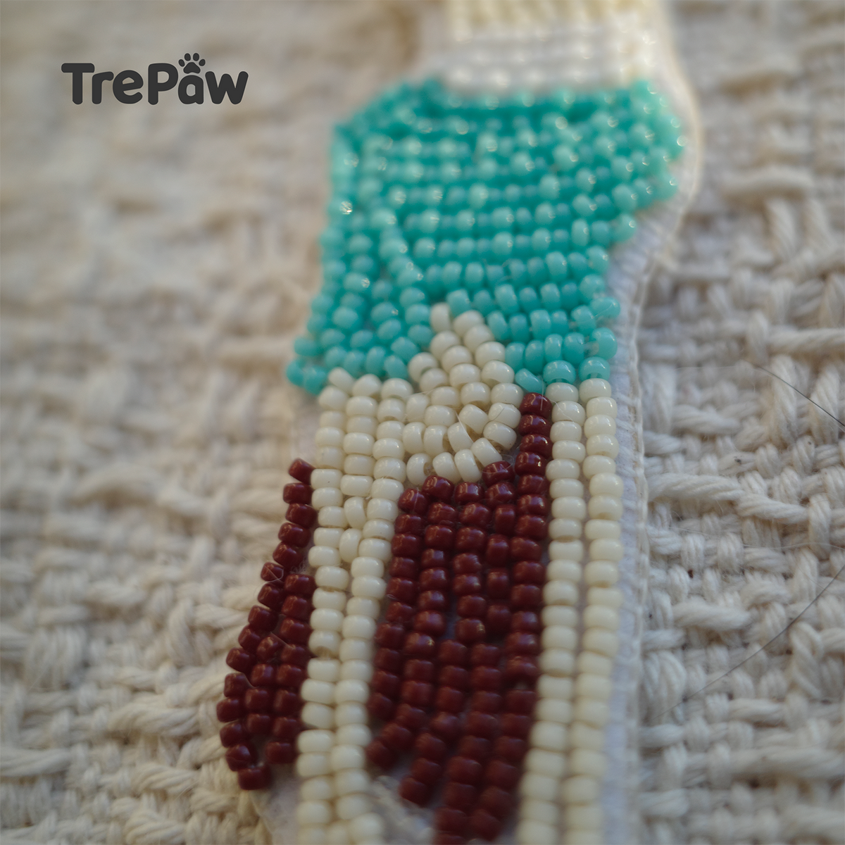 Close-up of Lazy Sunday bead embroidery showing the upside down girl and blue outfit