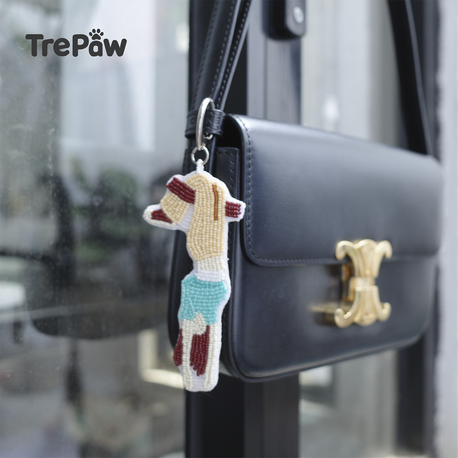 Lazy Sunday upside down girl beaded charm hanging from a bag