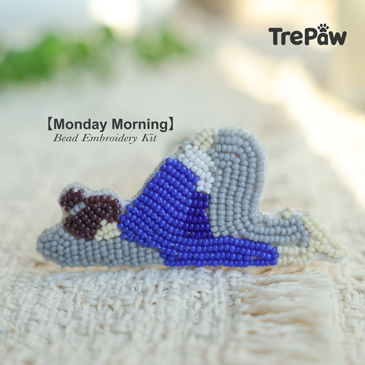 Monday Morning DIY bead embroidery kit featuring a sleepy girl in blue pajamas on a gray pillow