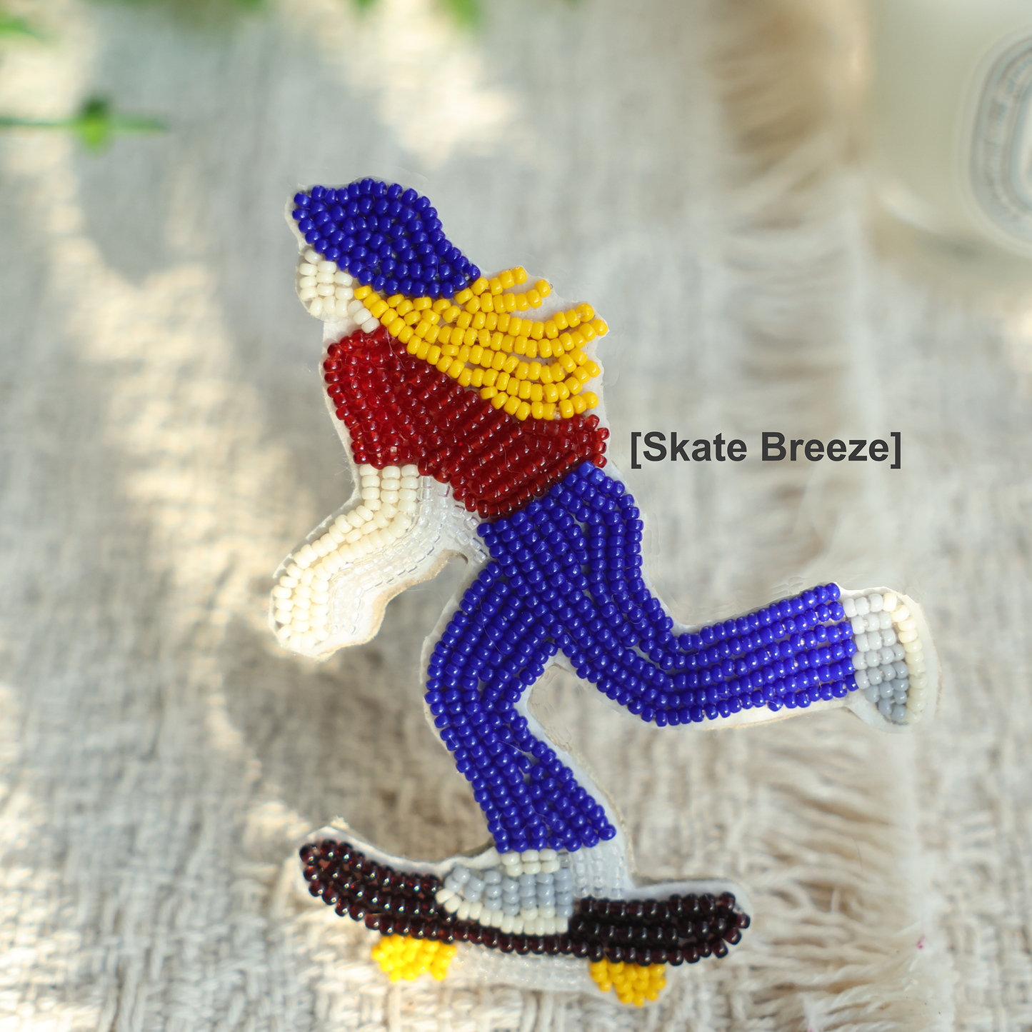Skate Breeze handmade bead embroidery charm attached to a phone case
