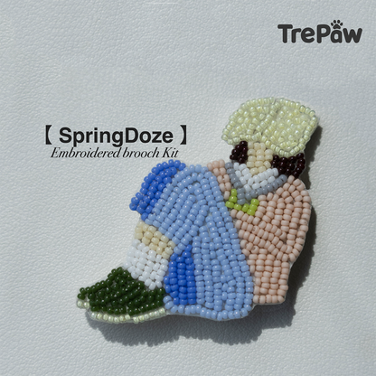 Spring Doze DIY bead embroidery kit featuring a girl resting under a tree with a book over her face
