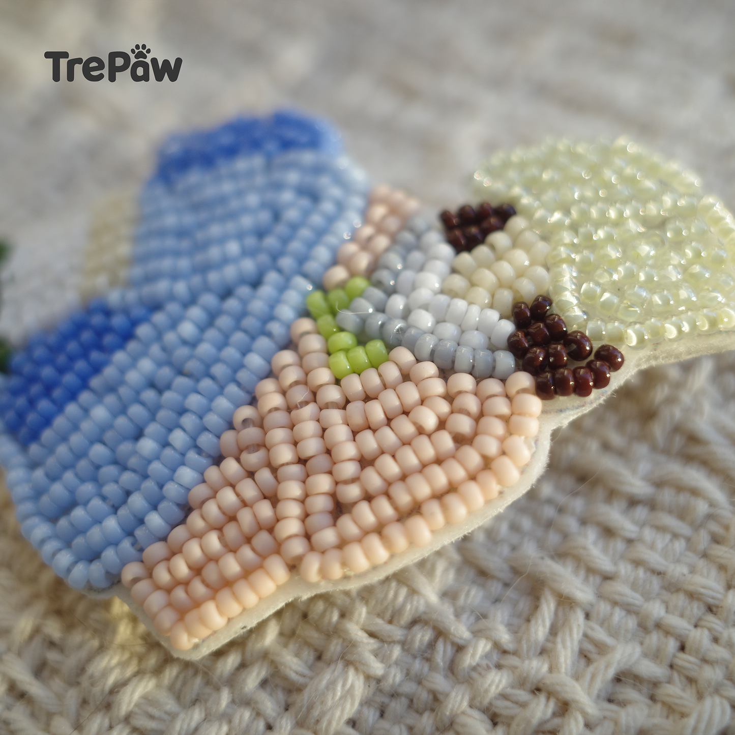 Close-up of Spring Doze bead embroidery with a girl resting under a tree