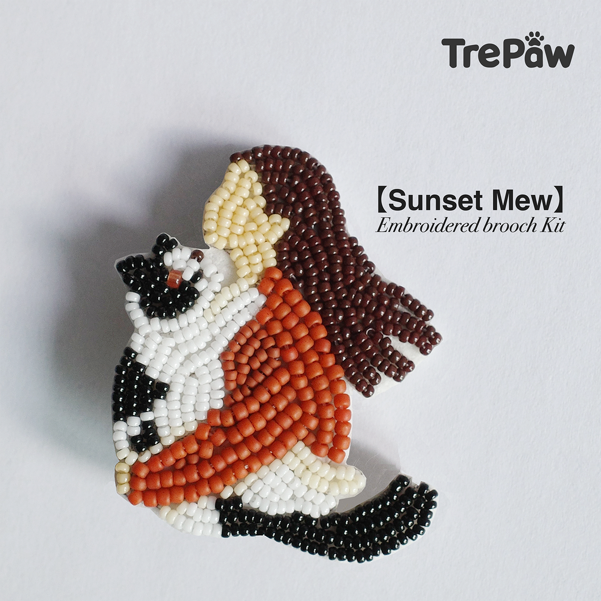 Sunset Mew bead embroidery kit - girl holding her first kitten, sunset colors, finished beaded brooch